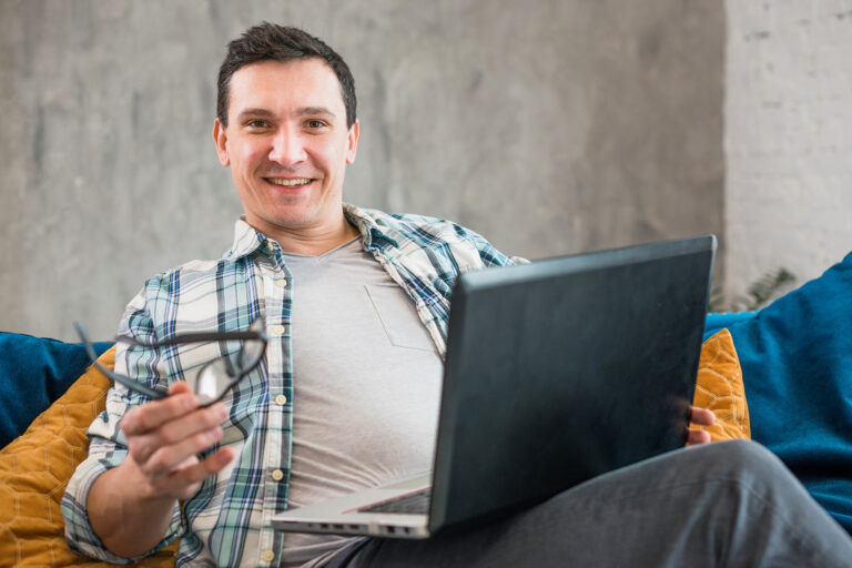 Photo of smiling man illustrates blog: "How Non-Recourse Factoring Protects Your Business From Bad Debt"