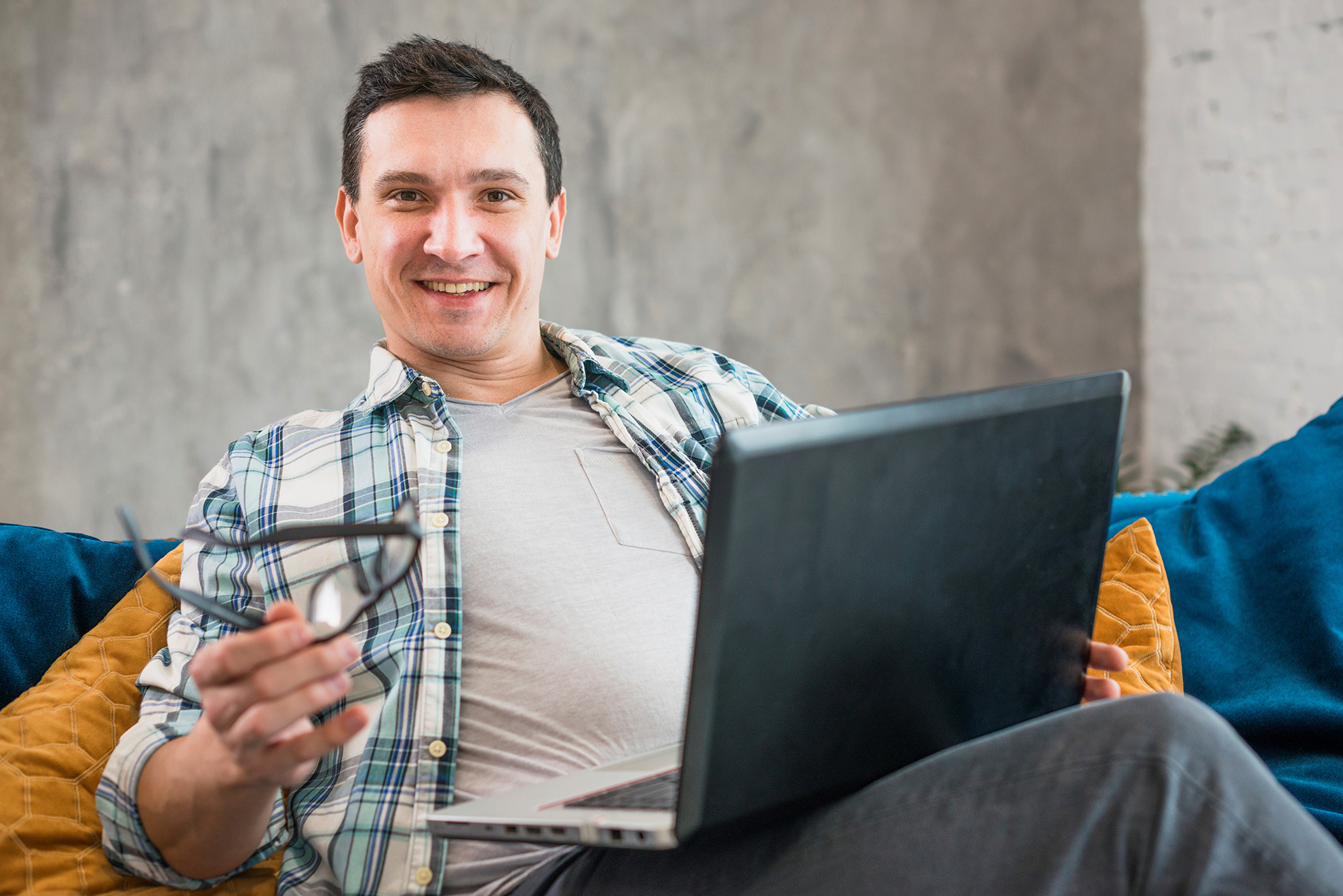 Photo of smiling man illustrates blog: "How Non-Recourse Factoring Protects Your Business From Bad Debt"