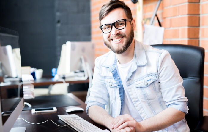 Photo of smiling man illustrates blog: "Receivables Factoring vs Receivables Securitization: What Is the Difference?"