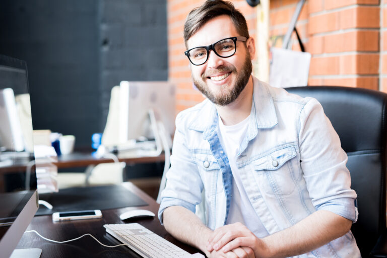 Photo of smiling man illustrates blog: "Receivables Factoring vs Receivables Securitization: What Is the Difference?"