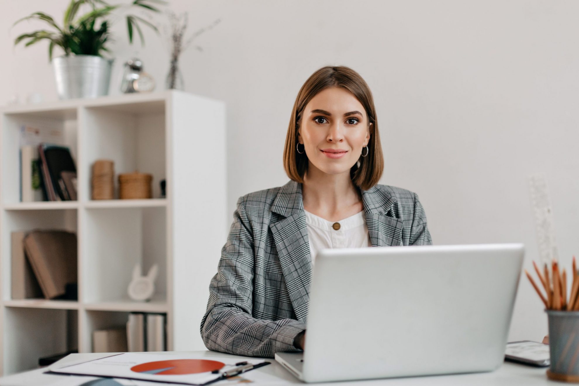 Photo of woman with laptop illustrates blog: "4 Things That Affect the Cash Flow of Your Small Business (and How to Solve Them)"