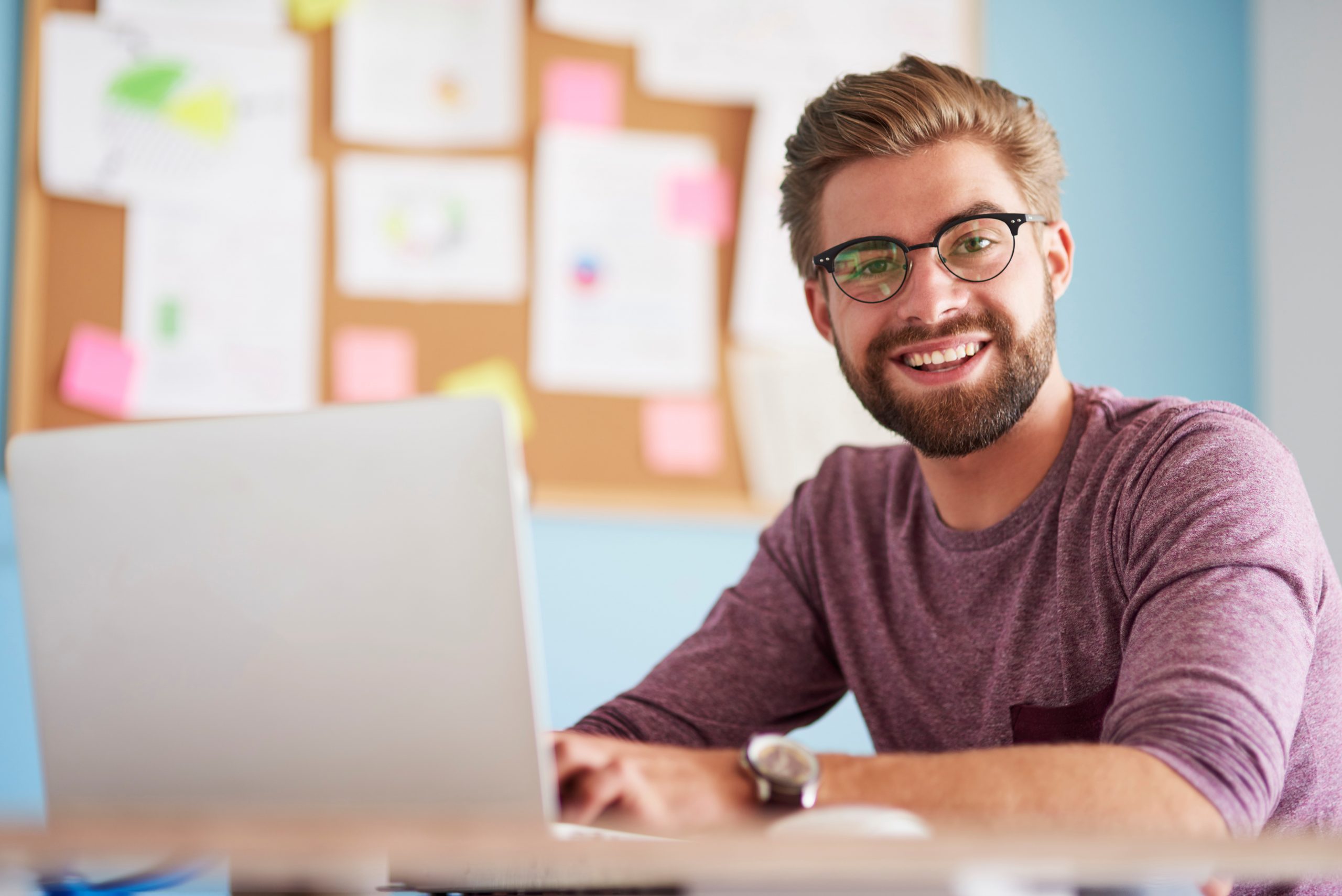 Photo of man looking at laptop illustrates blog: "Why Do Companies Factor Their Receivables?"