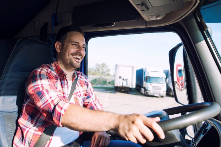 Closeup of trucker at the wheel illustrates blog "Is Factoring of Accounts Receivable a Good Idea for Trucking Companies?"