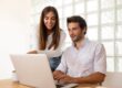 Man and woman looking at laptop illustrates blog "Are Cash Flow and EBITDA the Same?"