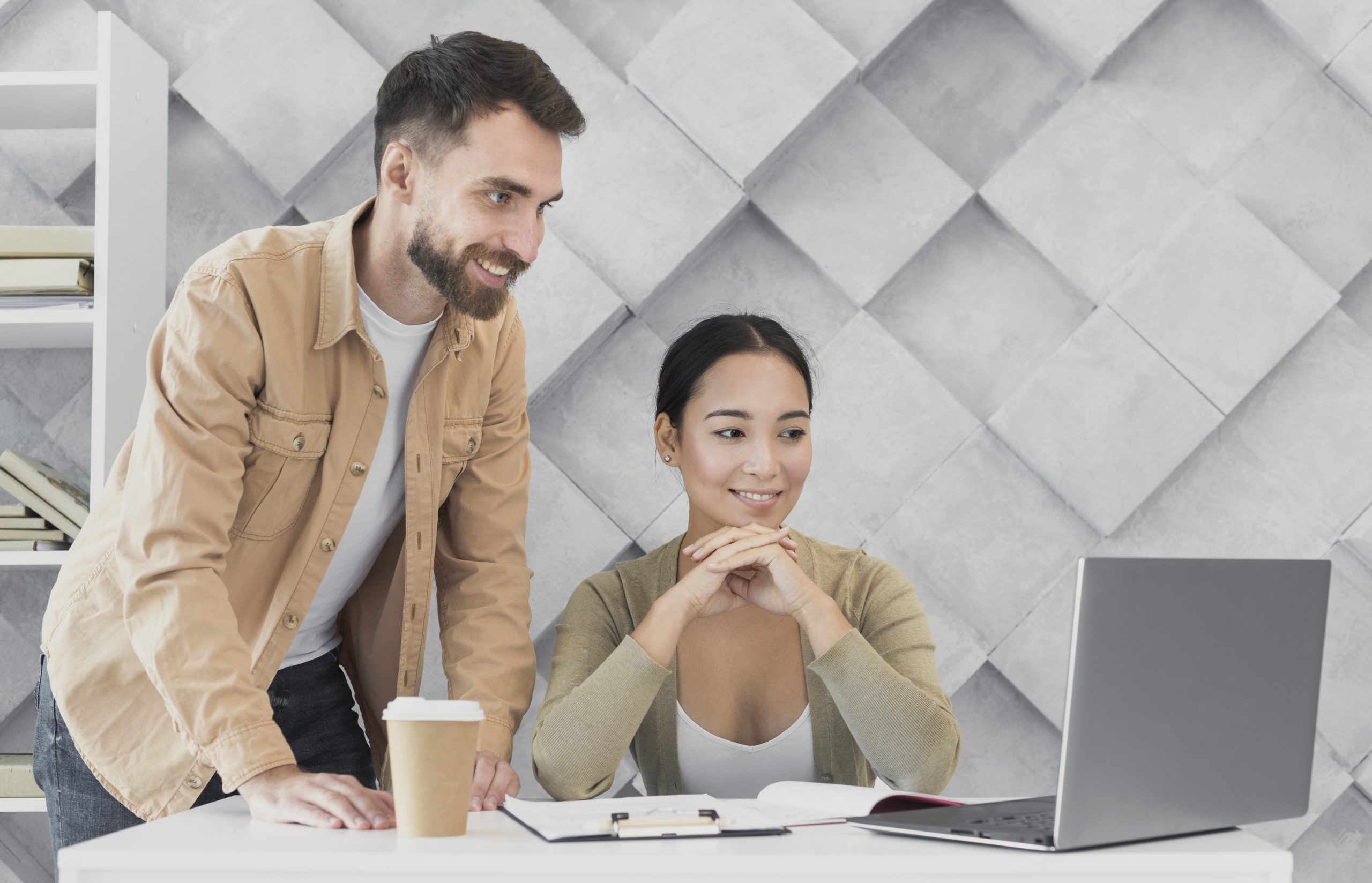 man-woman-laptop-office-fp Man and woman looking at laptop illustrate blog "What Are the Benefits of Receivables Management?"