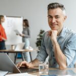 Man in office illustrates blog "What Does It Mean When Accounts Receivable Are Factored With Recourse?"