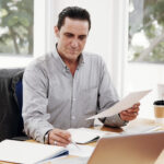 Invoice factoring candidates reviewing unpaid invoices for cash flow