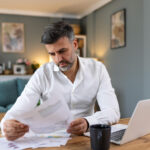 Business owner using digital invoice factoring in a paperless office