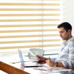 Small business owner analyzing cash flow mistakes in financial reports