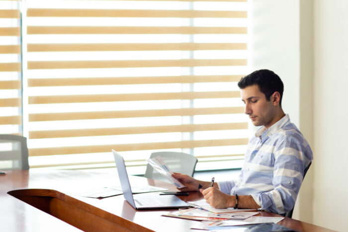 Small business owner analyzing cash flow mistakes in financial reports