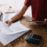 Business owner discussing invoice factoring misconceptions with financial advisor