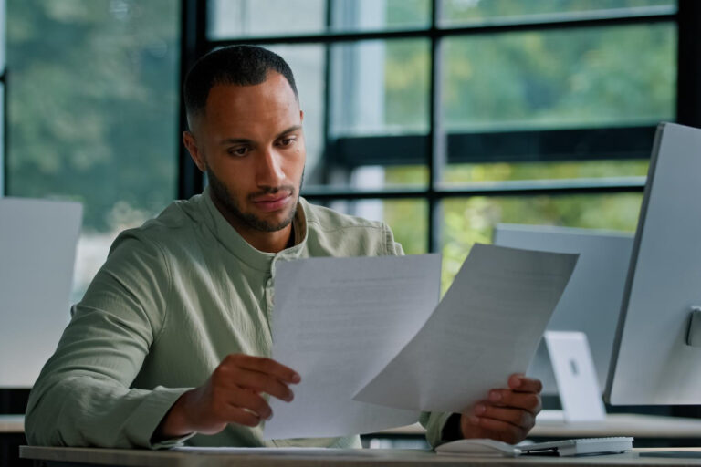 Business owner reviewing invoice factoring credit score impact on laptop