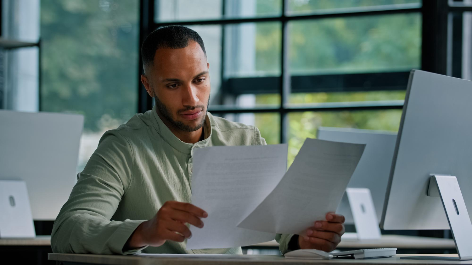 Business owner reviewing invoice factoring credit score impact on laptop