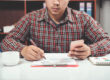 Business owner comparing Invoice Factoring vs Merchant Cash Advance options
