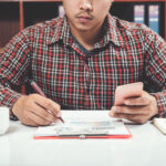 Business owner comparing Invoice Factoring vs Merchant Cash Advance options