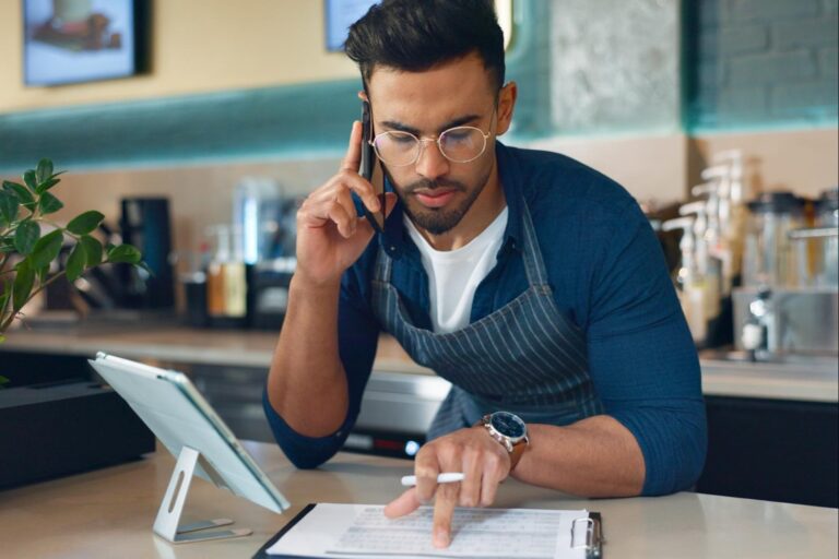 business-owner-phone-call-paperwork-restaurant-cafe-logistics-food-management-supply-chain-checklist-manager-man-mobile-communication-stock-inventory-coffee-shop-startup invoice factoring benefits for improving business cash flow