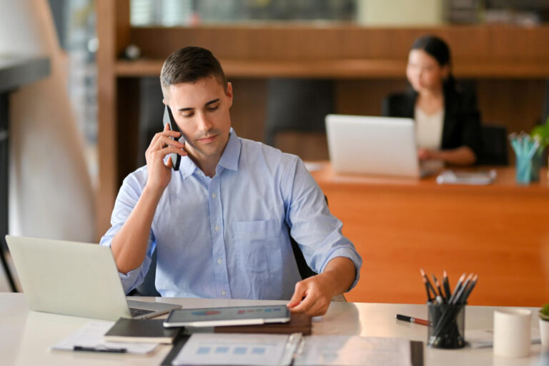portrait-young-woman-using-mobile-phone-office