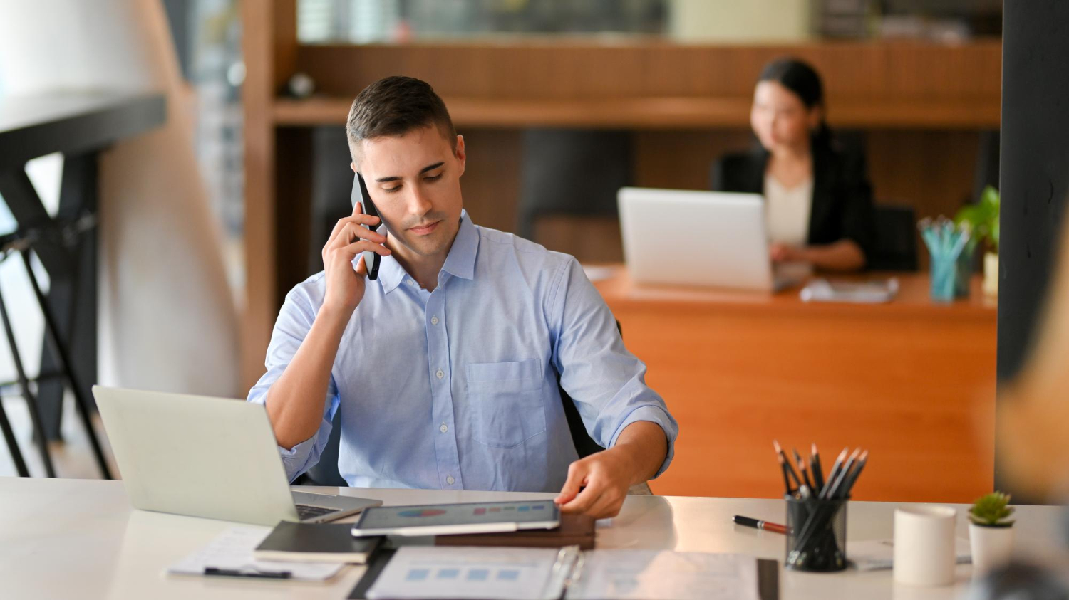 portrait-young-woman-using-mobile-phone-office
