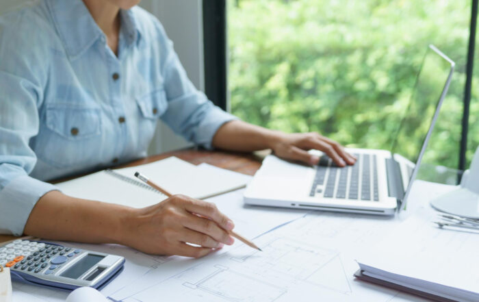 16657 invoice factoring benefits business owner reviewing invoices for cash flow