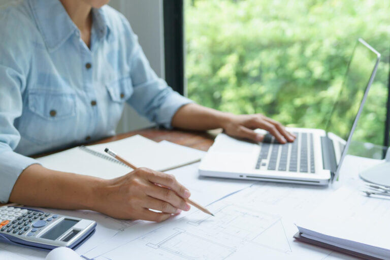 invoice factoring benefits business owner reviewing invoices for cash flow