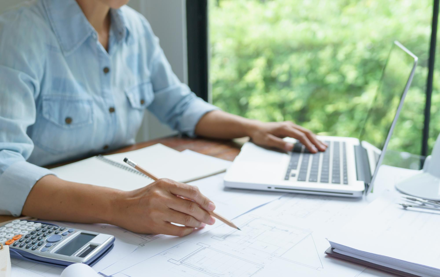 16657 invoice factoring benefits business owner reviewing invoices for cash flow