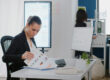 Business owner reviewing invoice factoring signs and cash flow pressure