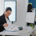 Business owner reviewing invoice factoring signs and cash flow pressure