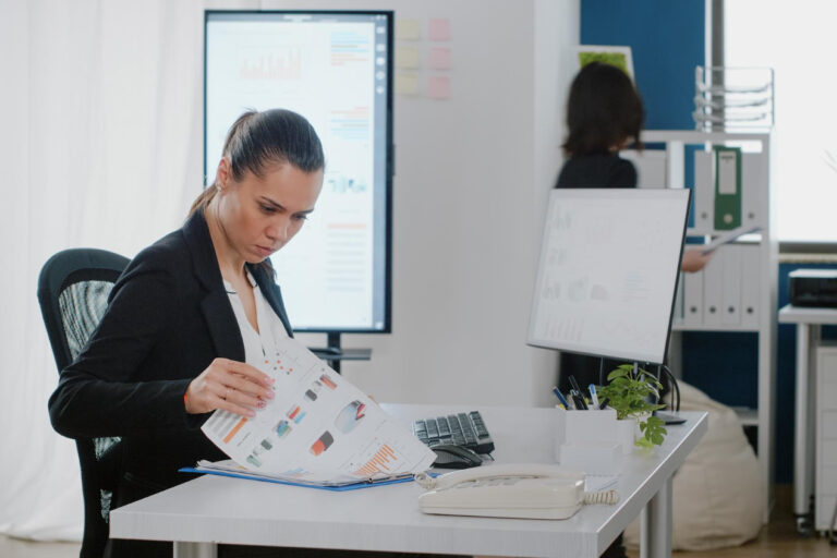 Business owner reviewing invoice factoring signs and cash flow pressure