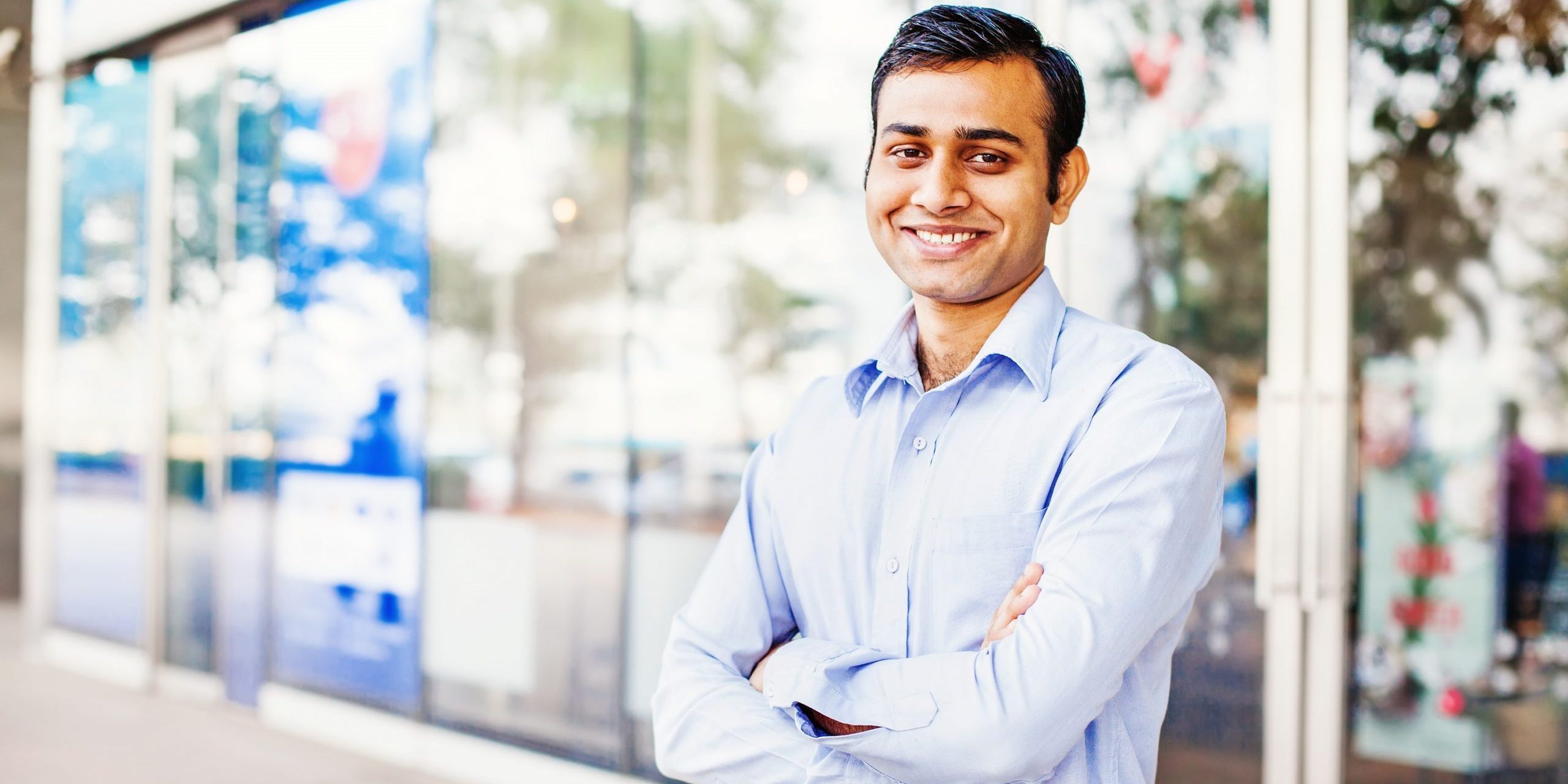 Photo of confident business owner illustrates blog: "4 Accounts Receivable Tips for Small Businesses"