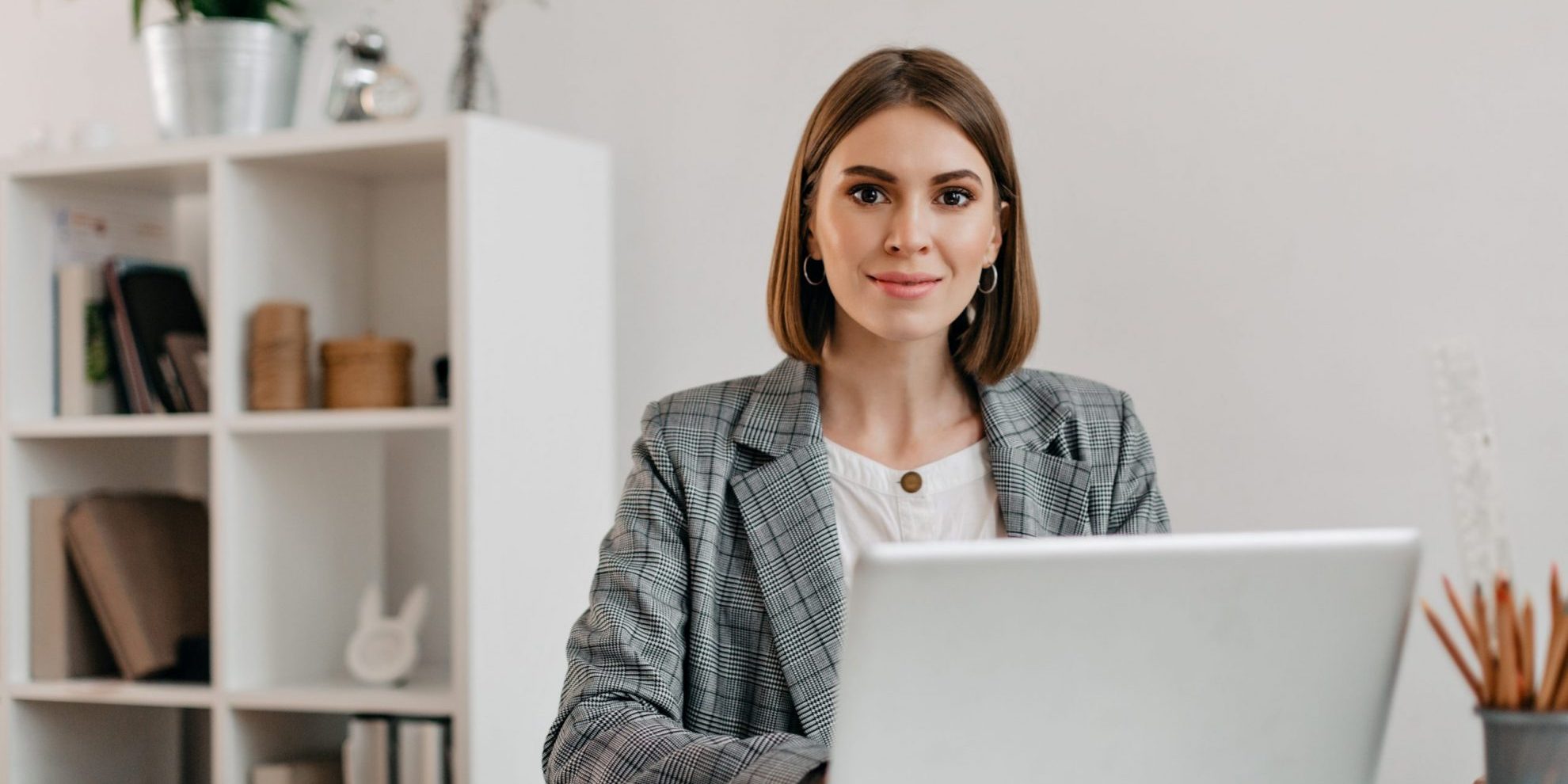 Photo of woman with laptop illustrates blog: "4 Things That Affect the Cash Flow of Your Small Business (and How to Solve Them)"