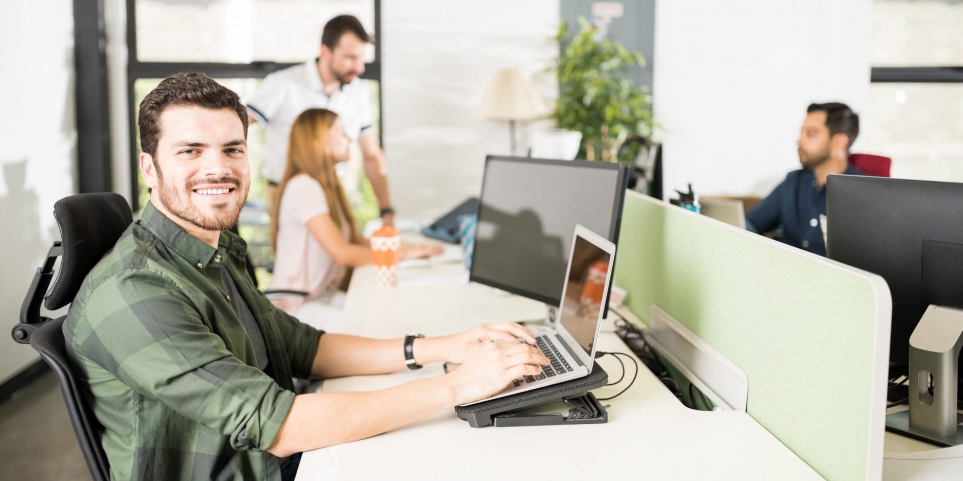 Photo of young businessman typing at computer illustrates blog: "4 Ways to Increase your Business’s Financial Strength"