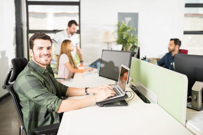 Photo of young businessman typing at computer illustrates blog: "4 Ways to Increase your Business’s Financial Strength"