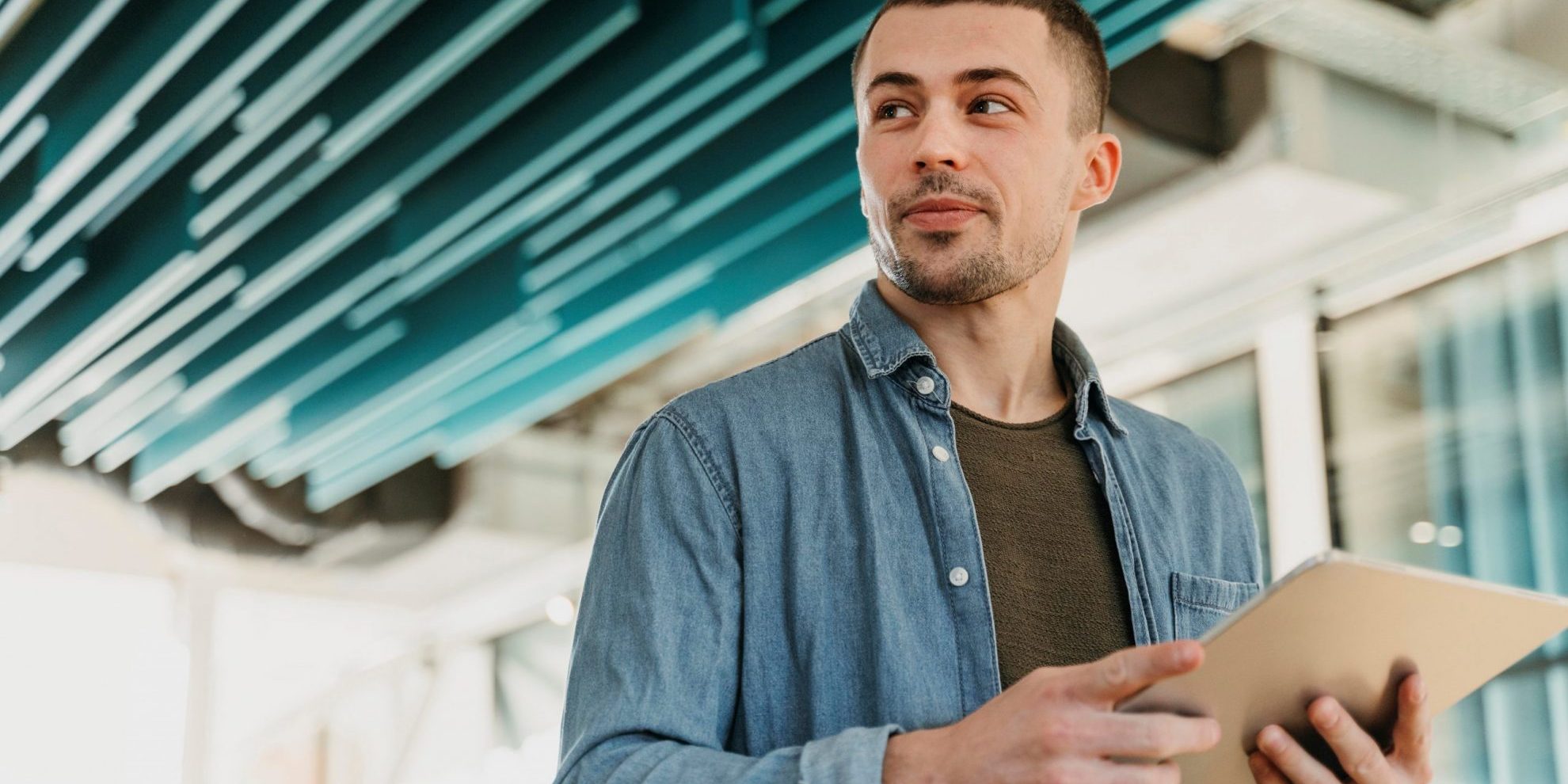 Photo of man holding clipboard illustrates blog: "3 Reasons to Choose Factoring Over Bank Loans"