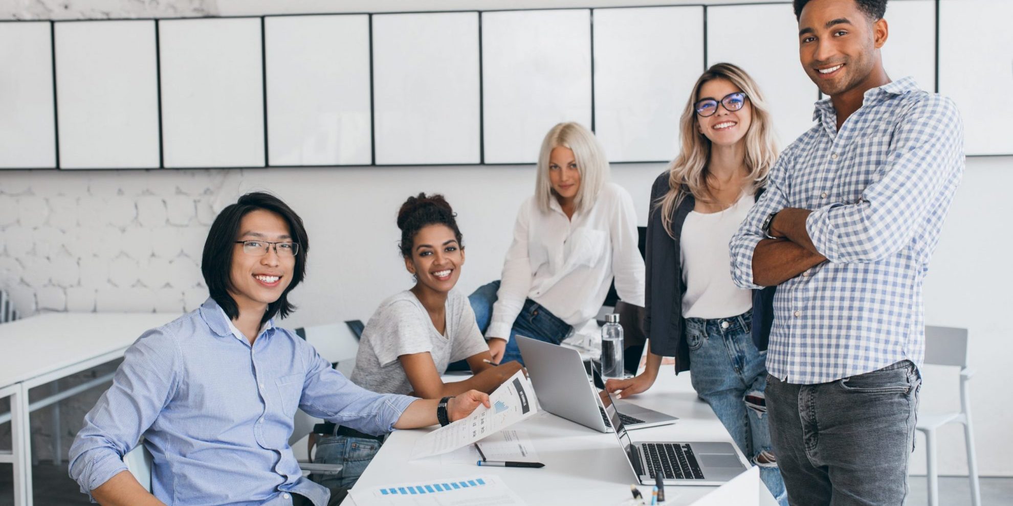 Team of five people in office illustrates blog: " Factoring Helps Companies in the Service Industry"