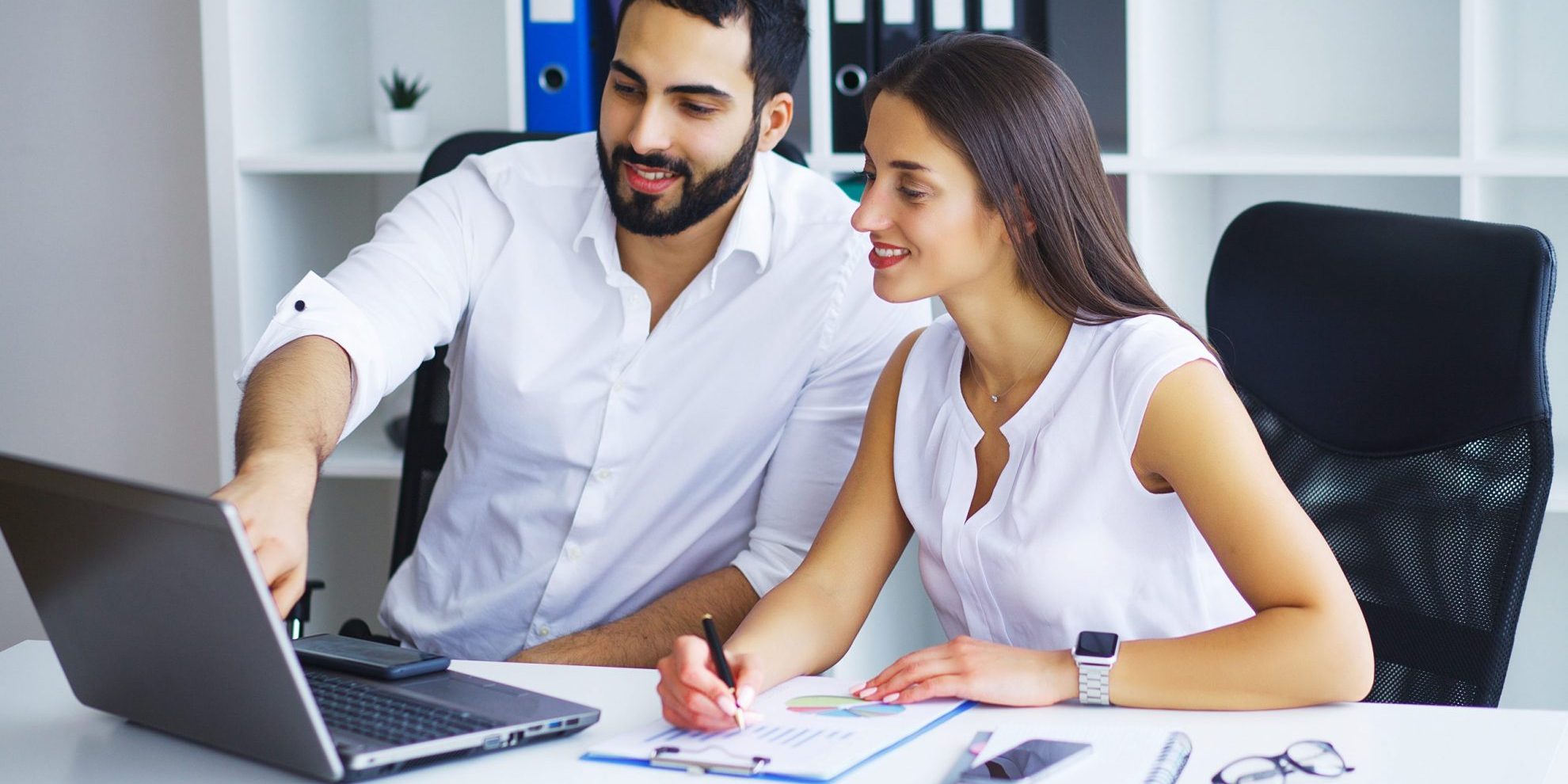 Man and woman looking at laptop illustrate blog "Are Accounts Receivable Assets or Liabilities?"
