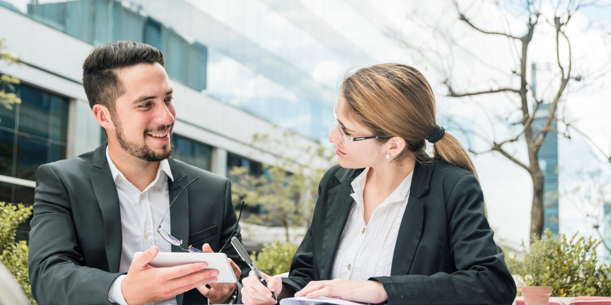 Man and woman in business attire illustrate blog " Invoice Factoring vs. Line of Credit: Which One is Better for Your Business?"