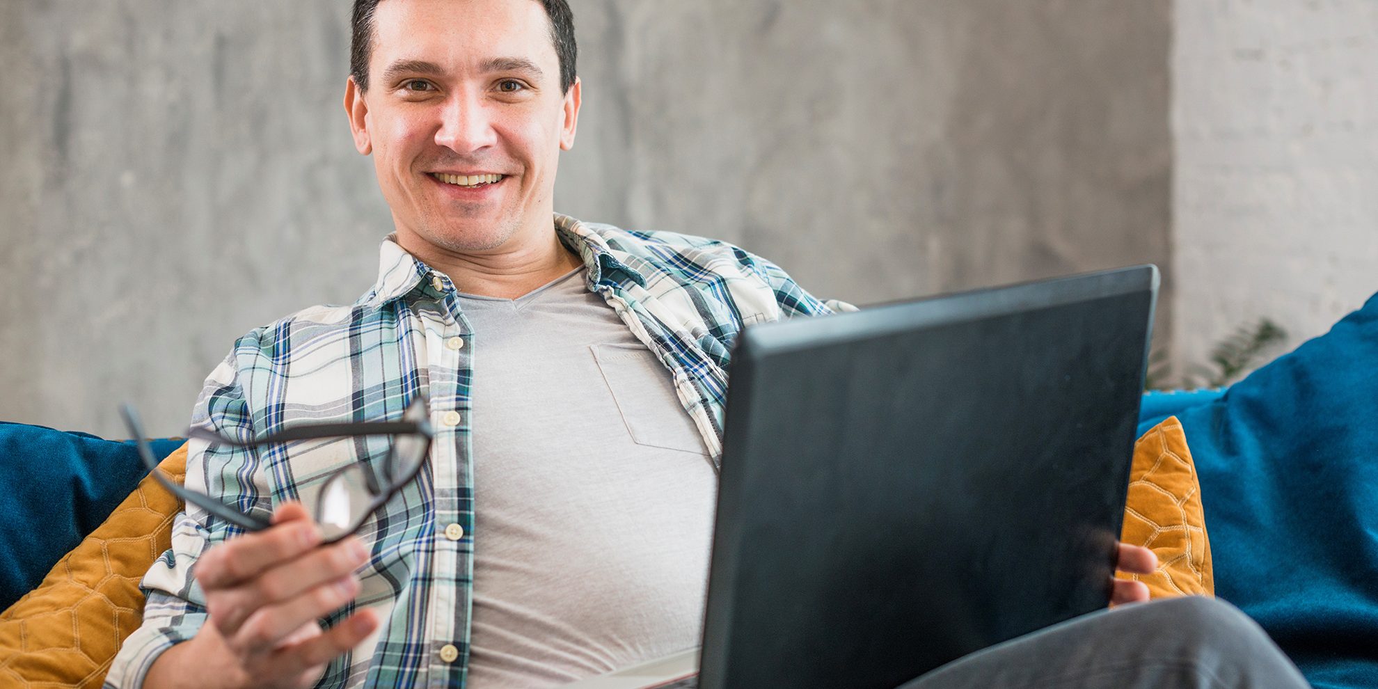 Photo of smiling man illustrates blog: "How Non-Recourse Factoring Protects Your Business From Bad Debt"