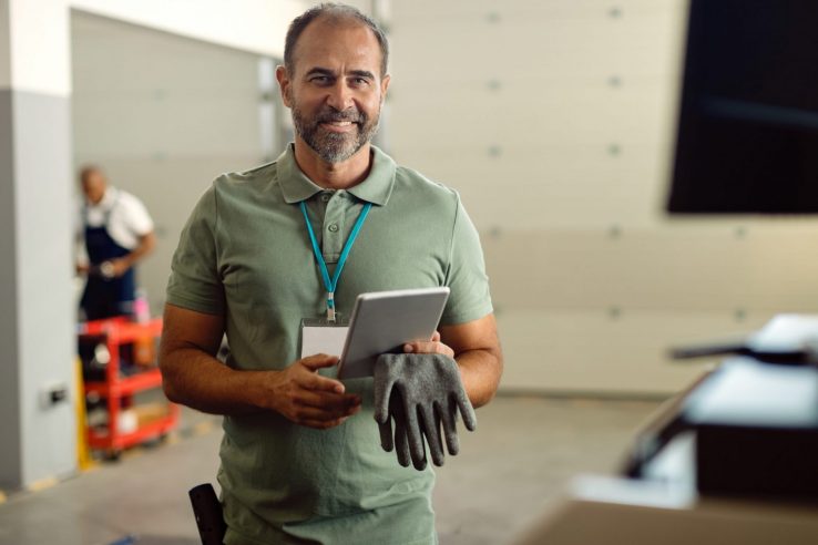 Photo of smiling business owner illustrates blog: "Small Businesses Can Benefit From Using Factoring To Pay Operating Expenses"