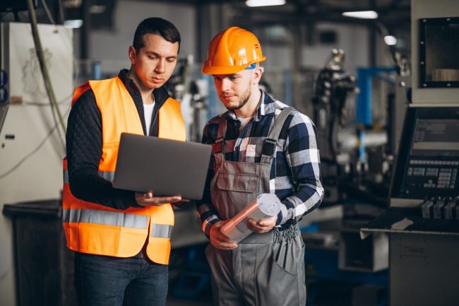 Photo of men in warehouse illustrates blog: "Factoring of Accounts Receivable vs Supply Chain Finance: What Is the Difference?"