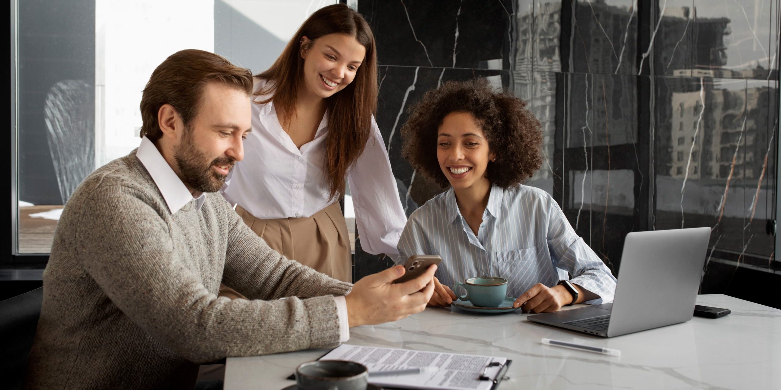 bad-debt-FP Office workers looking at smartphone illustrate blog "4 Tips To Avoid Bad Debt"