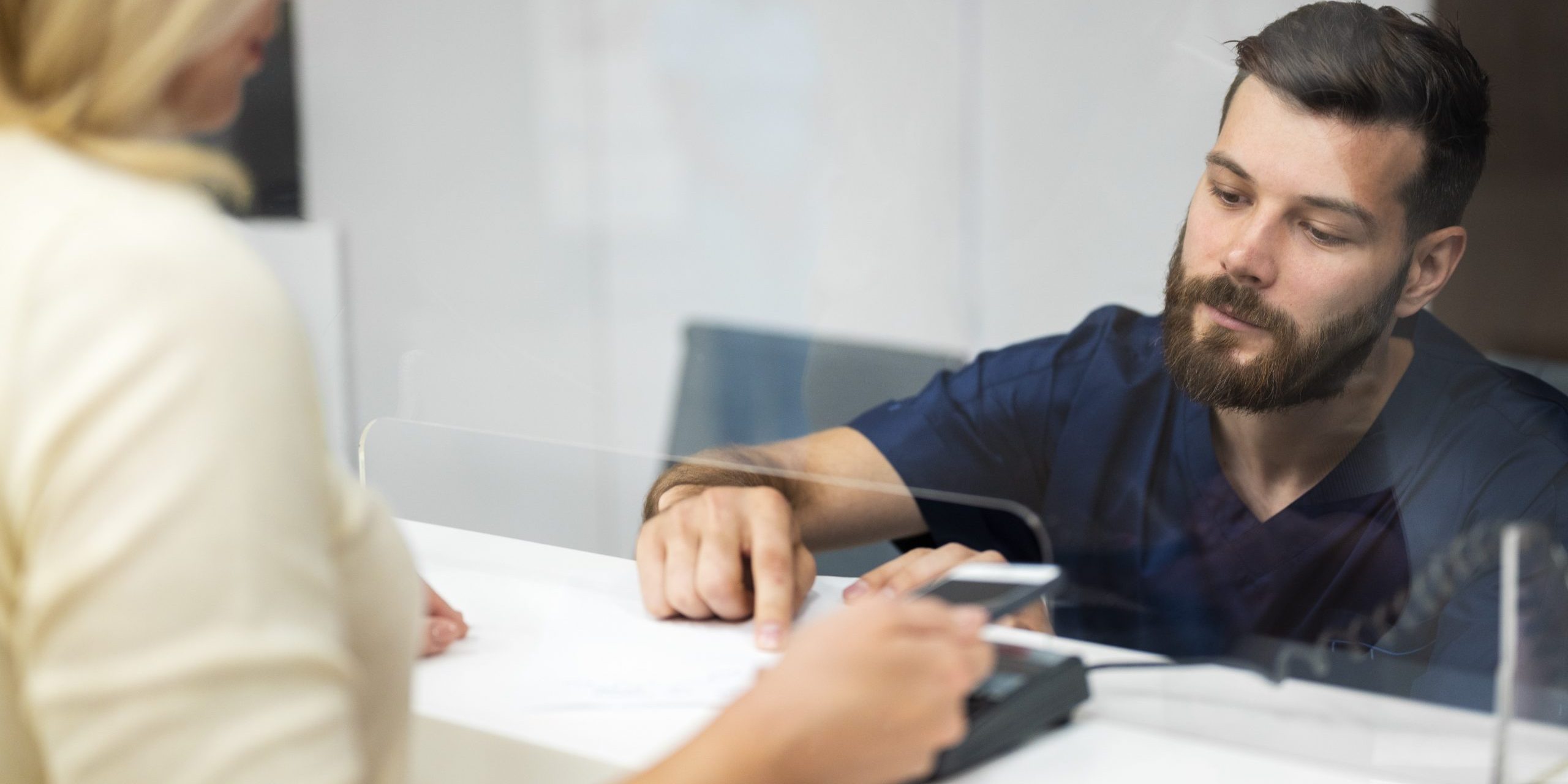 Bank customer talking to teller illustrate blog "Bank Loans Are Getting Harder To Obtain: Here’s Why (and What To Do About It)"