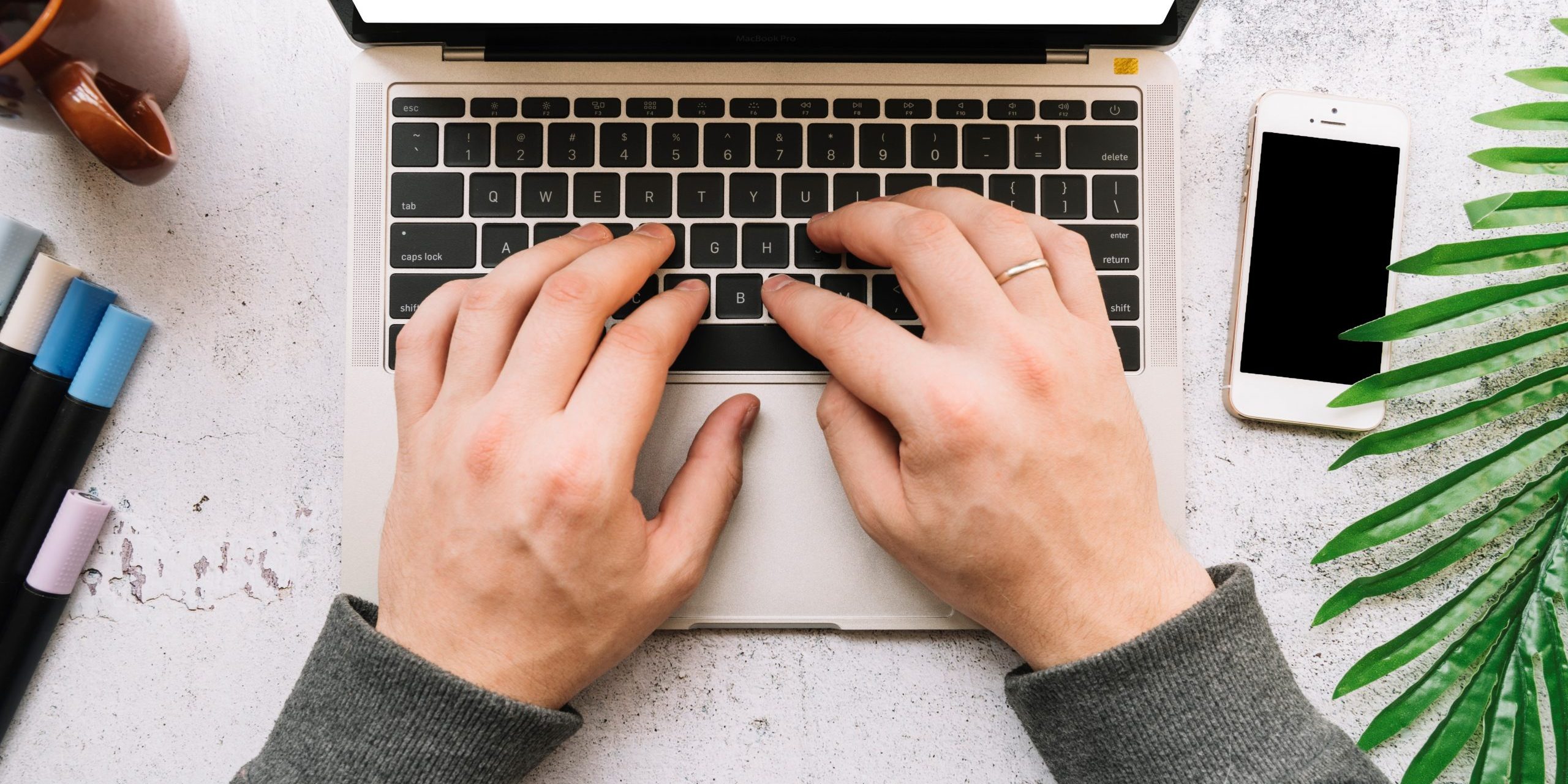 Closeup of man working on laptop illustrates blog