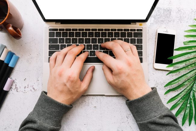 Closeup of man working on laptop illustrates blog