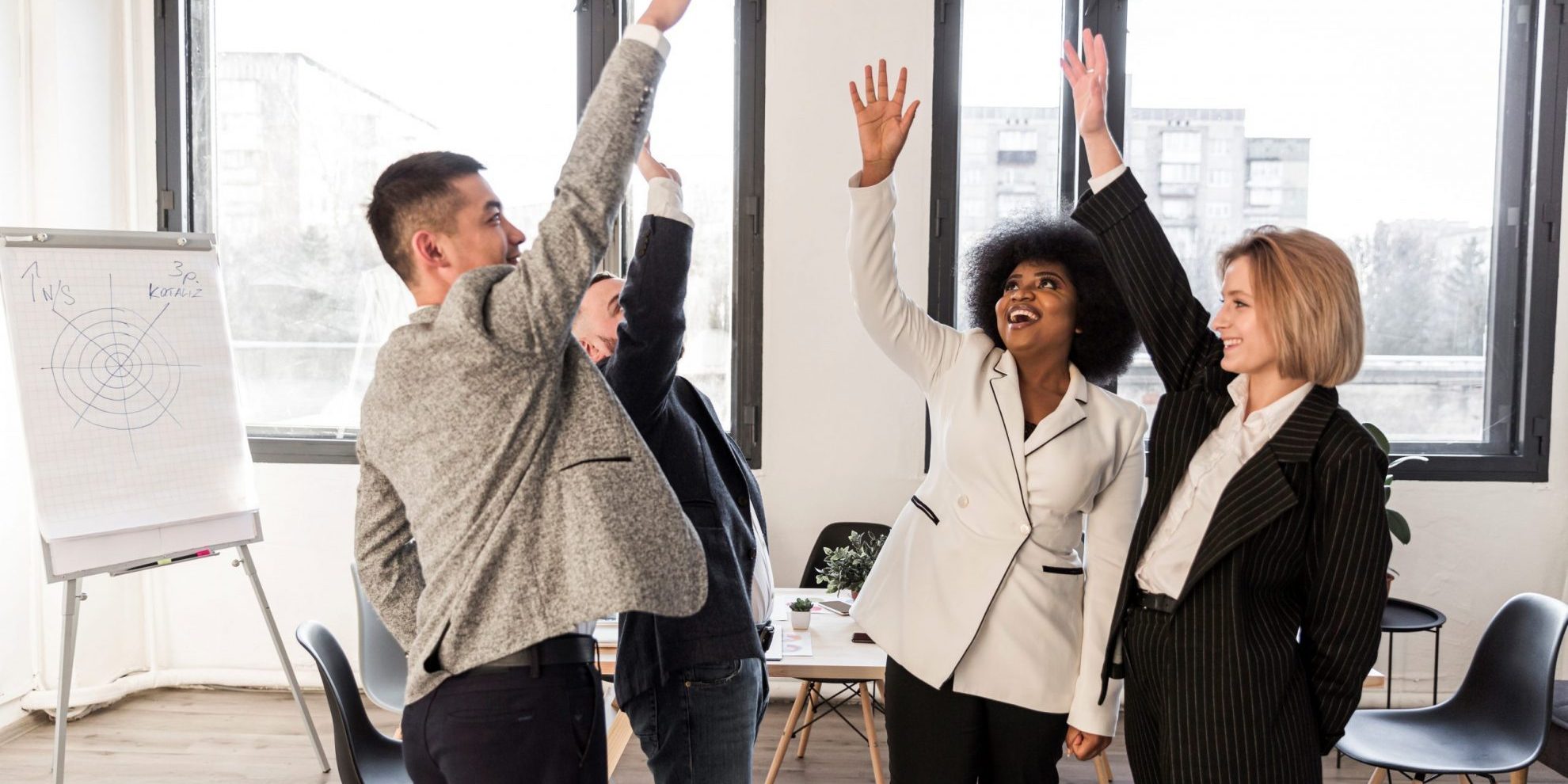 high-five-FP Group of four people high-fiving each other illustrates blog "4 Ways to Fund Business Growth"