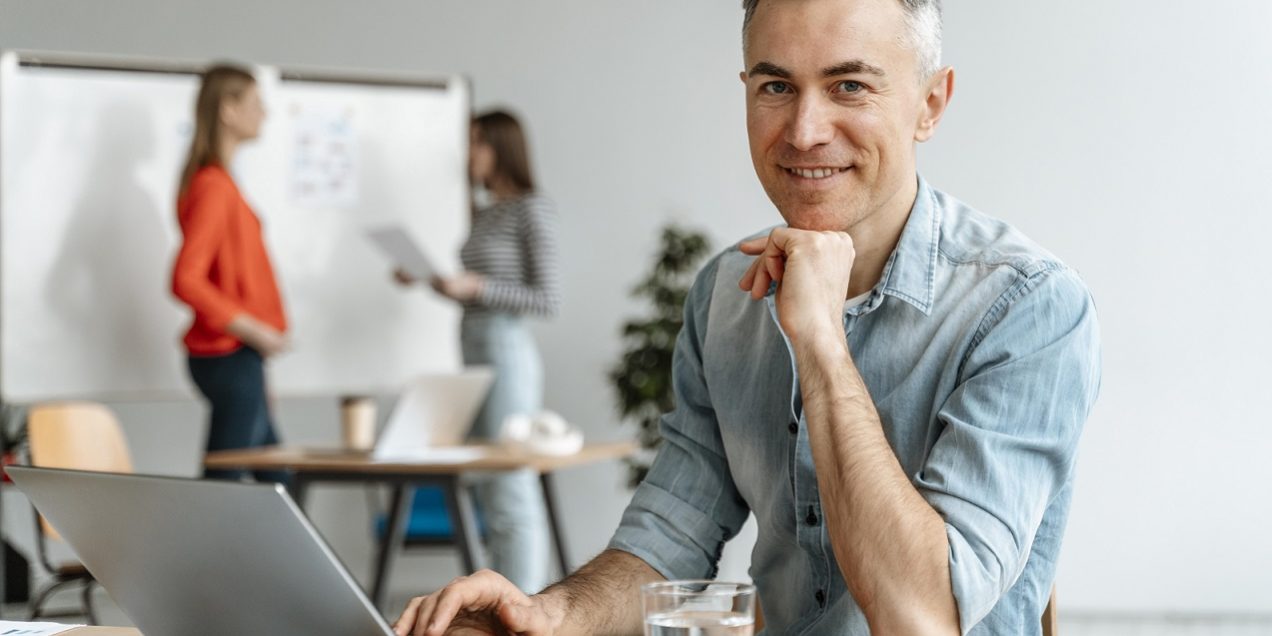 Man in office illustrates blog "What Does It Mean When Accounts Receivable Are Factored With Recourse?"