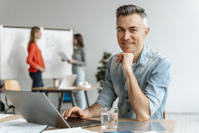 Man in office illustrates blog "What Does It Mean When Accounts Receivable Are Factored With Recourse?"