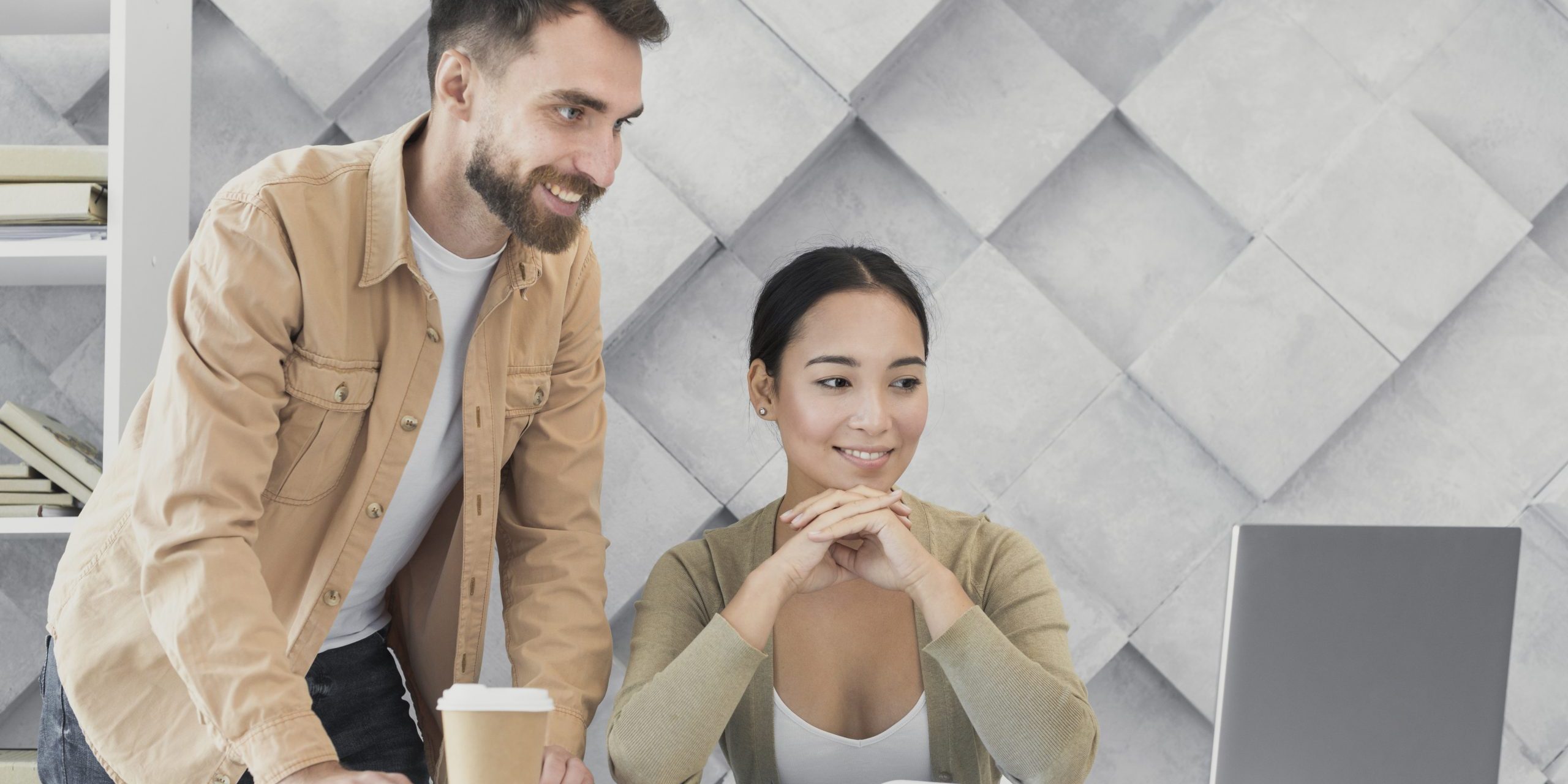 man-woman-laptop-office-fp Man and woman looking at laptop illustrate blog "What Are the Benefits of Receivables Management?"