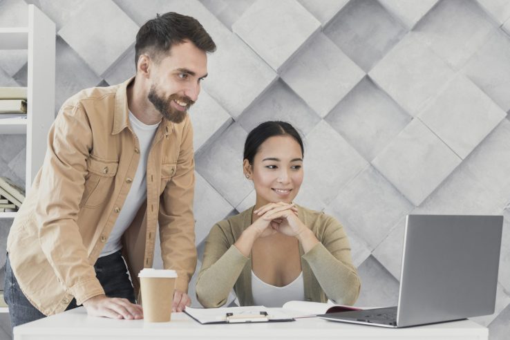 man-woman-laptop-office-fp Man and woman looking at laptop illustrate blog "What Are the Benefits of Receivables Management?"