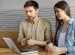 Two casual people in office illustrate blog "Factoring vs Assignment of Receivables: What is the Difference?"