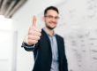 Man giving thumbs up illustrates blog "What Does 'Cash Flow-Positive' Mean?"